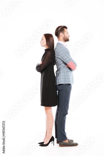 Offended serious loving couple standing isolated