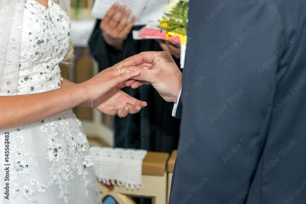 The bride and groom exchange with rings. The bride and groom exchange with rings.