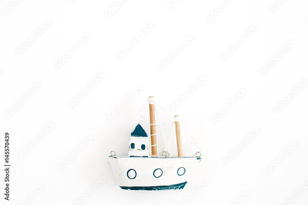 Wooden handmade toy boat on white background. Flat lay, top view