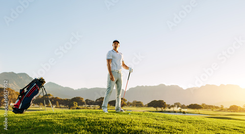 Male golfer standing on golf course