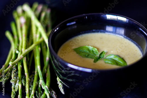 Asparagus soup in a black bowl 
