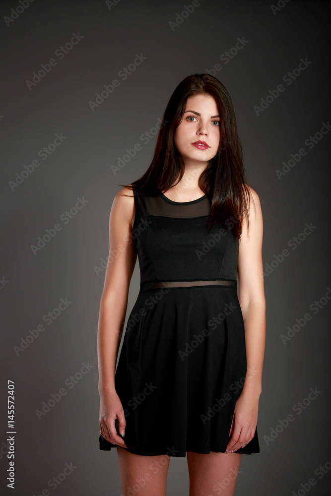 Portrait of beautiful brunette woman in black dress. Fashion photo Portrait of beautiful brunette woman in black dress. Fashion photo
