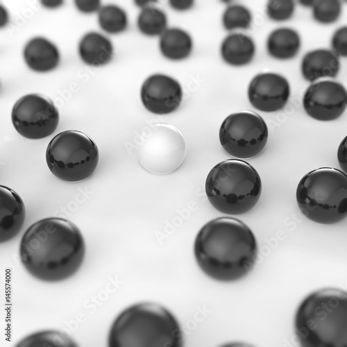Scattered black balls on the white floor with one white ball