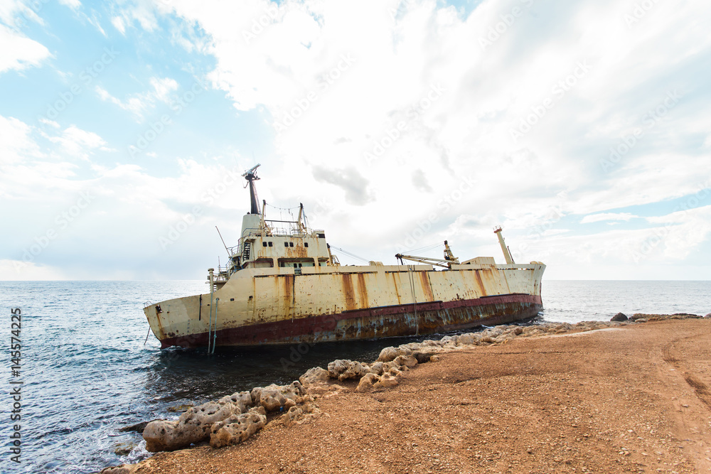 Abandoned broken ship-wreck beached on rocky sea shore. Abandoned broken ship-wreck beached on rocky sea shore.