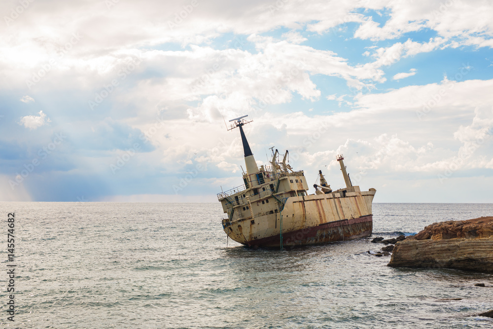 Abandoned broken ship-wreck beached on rocky sea shore. Abandoned broken ship-wreck beached on rocky sea shore.