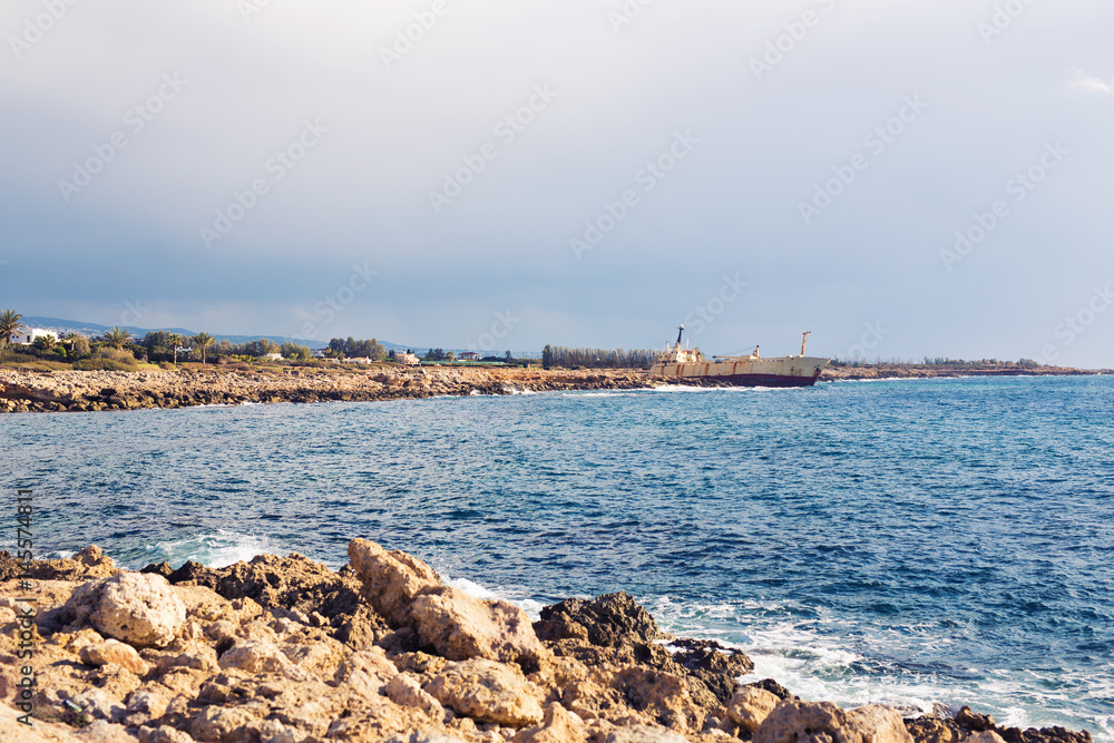 Ship wreck surrounded by sea waves on beach, Cyprus