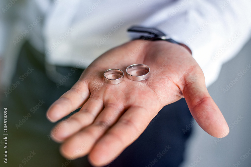 Fototapeta premium A man holds in his hands a wedding ring.