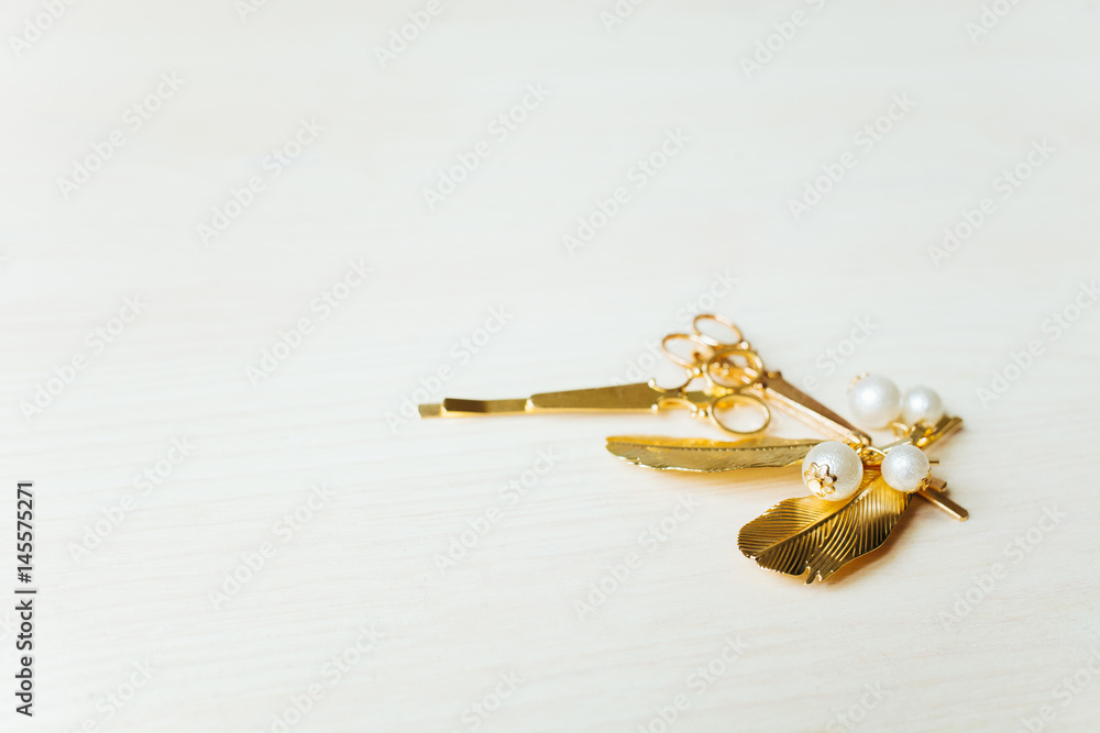 Women's jewelry on a white wooden background. Barrettes and earrings
Women's jewelry on a white wooden background. Barrettes and earrings