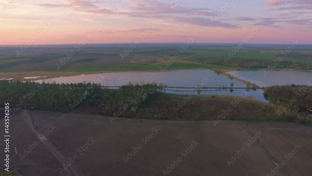 Aerial felled forest near river canal. Environmental consequences. Natural disaster. Evening