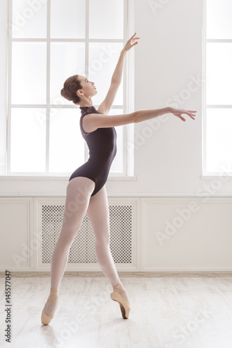 Beautiful ballerina stands on pointe, ballet position