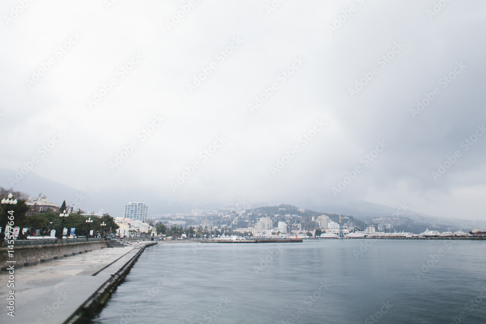 The promenade of Yalta. The port in the black sea. Cloudy weather on the black sea. The City Of Yalta- Crimea
The promenade of Yalta. The port in the black sea. Cloudy weather on the black sea. The City Of Yalta- Crimea