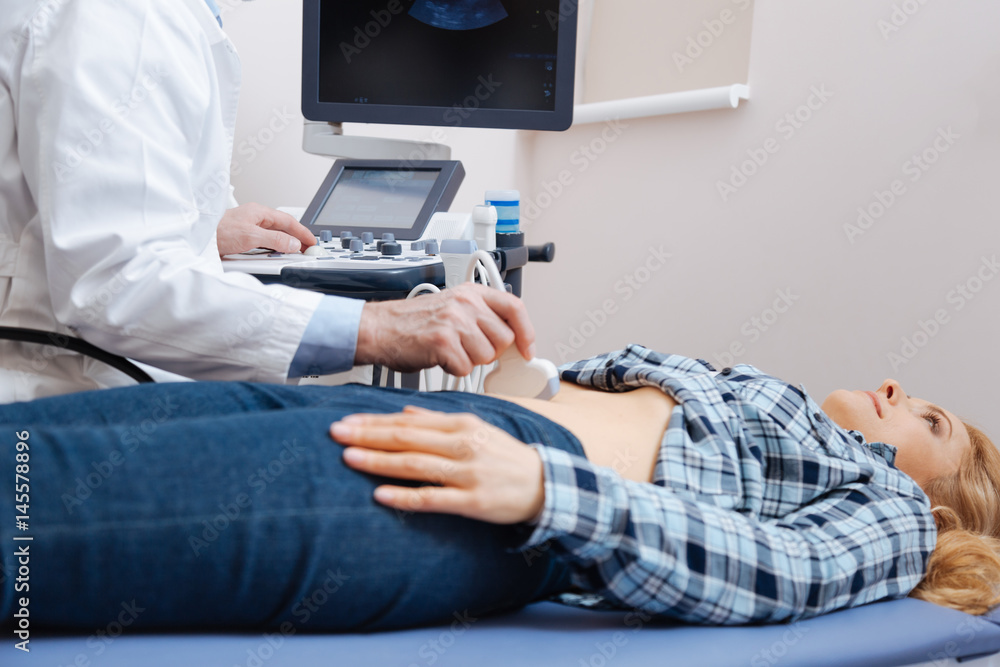 Proficient medical specialist having appointment in the sonography cabinet Proficient medical specialist having appointment in the sonography cabinet