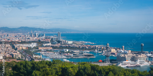 Beautiful Blue commerce. Coastline of Spain in seaside Barcelona. Modern city scape & coastline as seen from high level, cable car over the city. 