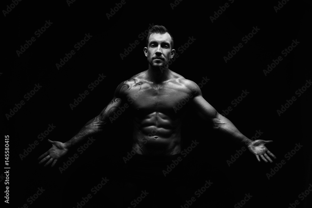 Strong athletic man showes naked muscular body Strong athletic man showes naked muscular body