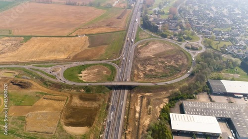 Busy junction feeding traffic in and out of highway, aerial hyperlapse photo