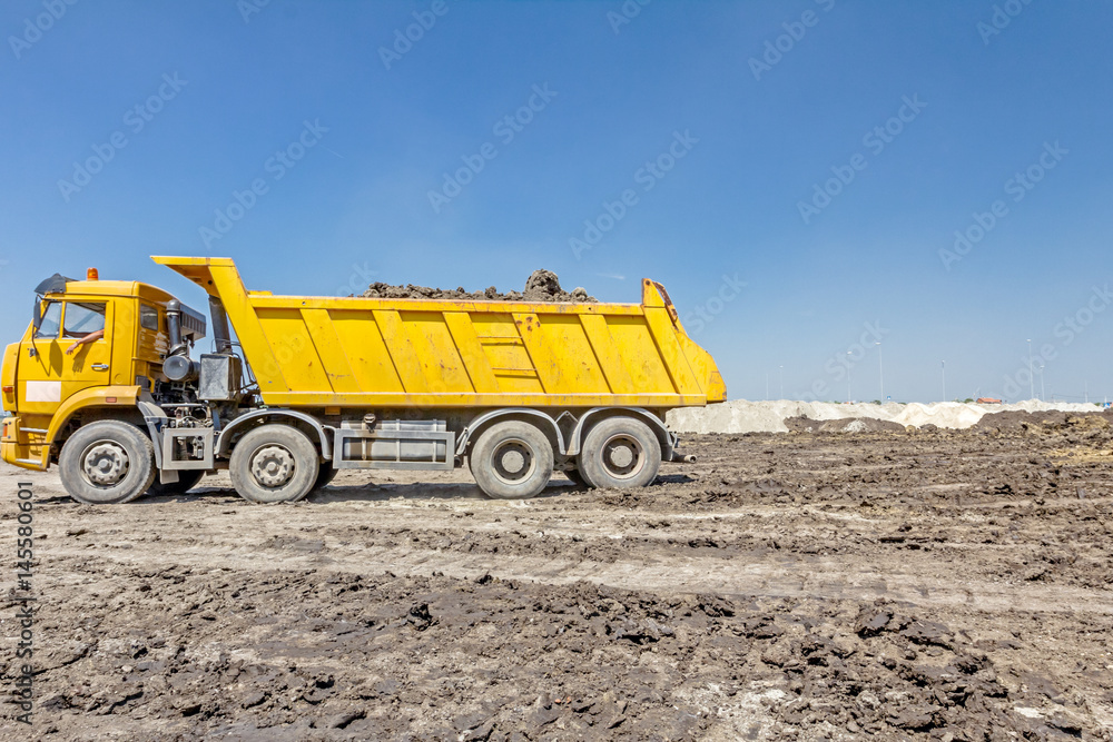 Dumper truck is going backward to unload soil