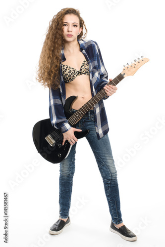 Young guitarist girl posing on white background;