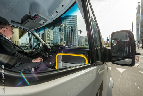 Fototapeta Naklejka Na Ścianę i Meble -  Professional Driver Driving Taxi On City Street