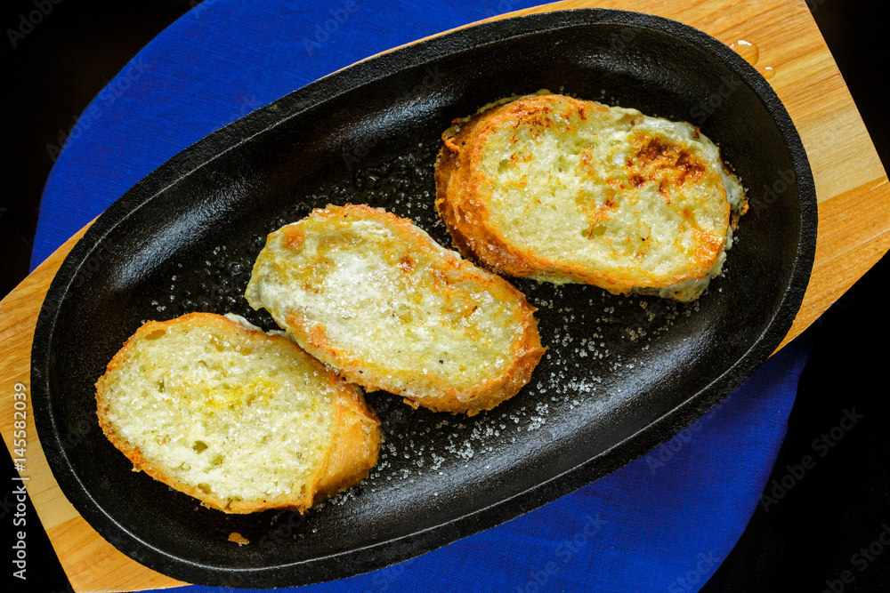 Sweet croutons on a cast-iron frying pan. Top view. Sweet croutons on a cast-iron frying pan. Top view.