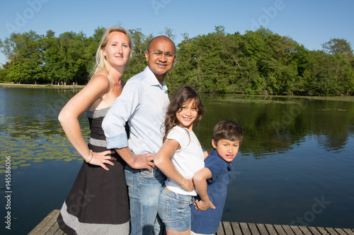 mixed race racial family near the lake with blond and indian © OceanProd