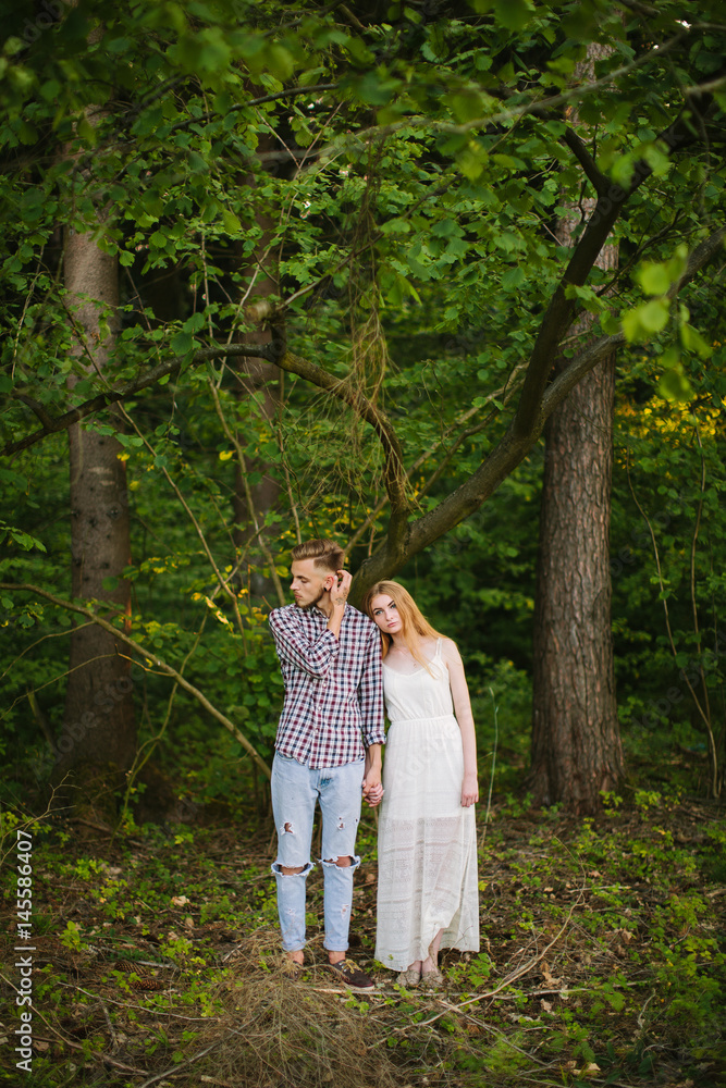 Beautiful Love story in the woods. Portrait of young stylish couple. Beautiful Love story in the woods. Portrait of young stylish couple.