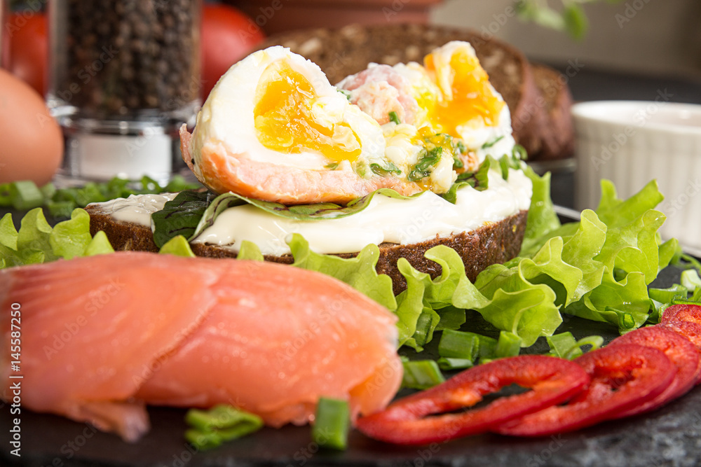 Toast with salmon, pepper, cream cheese, chives and poached egg Toast with salmon, pepper, cream cheese, chives and poached egg
