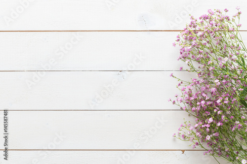 Mother's day background, white wooden table with pink flowers © andreaobzerova
