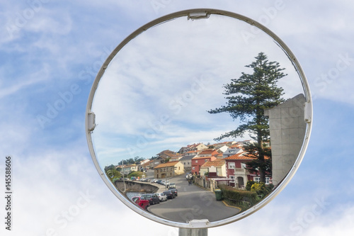 Village reflected on a traffic convex mirror photo