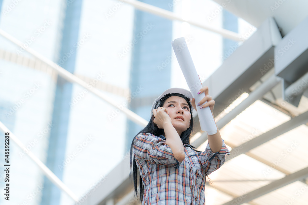 Fototapeta premium Asian Engineer Woman on activity in Site construction project