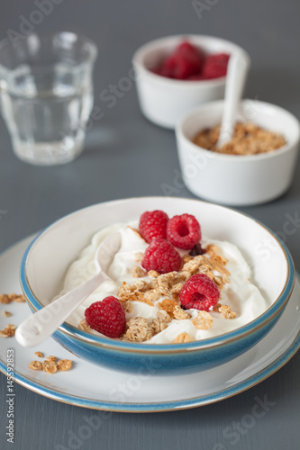yogurt with granola and raspberry for healthy breakfast