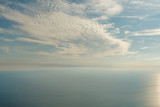 Blue sky with clouds and airplane trails over the Black sea. Nature composition in Crimea, Ukraine 2011.