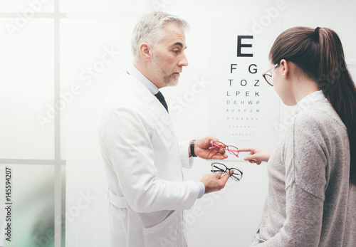 Woman choosing a pair of glasses