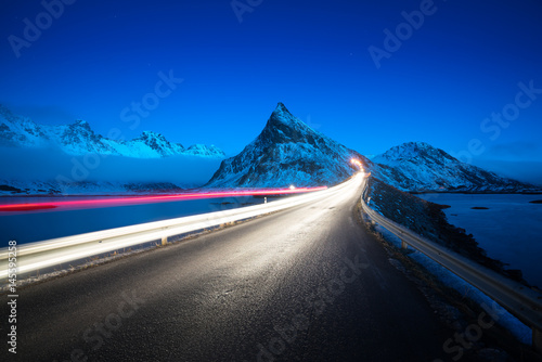 Olstind Mount and car light. Lofoten islands? spring time, Norway photo