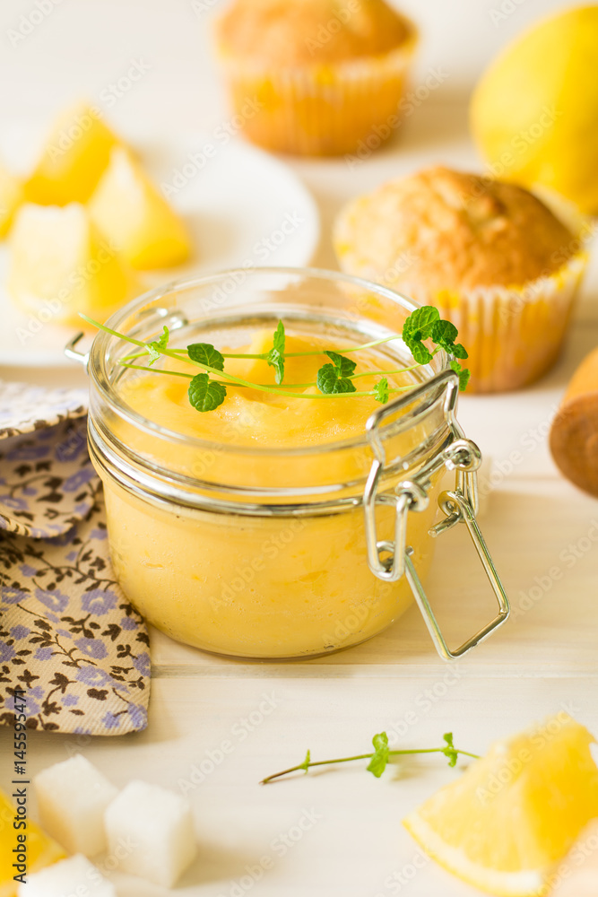 Preparing lemon cupcakes with citrus curd on white wooden background. Selective focus Preparing lemon cupcakes with citrus curd on white wooden background. Selective focus