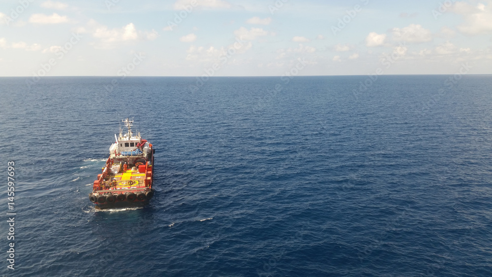 Supply boat transfer cargo to oil and gas industry and moving cargo from the boat to the platform Supply boat transfer cargo to oil and gas industry and moving cargo from the boat to the platform