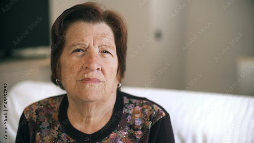 thoughtful old woman in her thoughts sitting on the couch,portrait thoughtful old woman in her thoughts sitting on the couch,portrait
