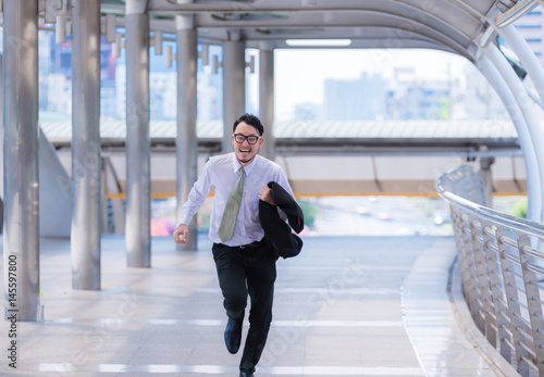Stressed anxious businessman in a hurry and running, he is late for his business appointment and Wear a shirt while running.