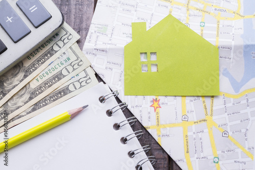 Notebook, pencil, calculator to make the budget of buying house