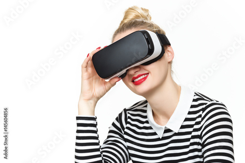 Attractive woman wearing virtual reality glasses. VR headset. Virtual reality concept on white background.