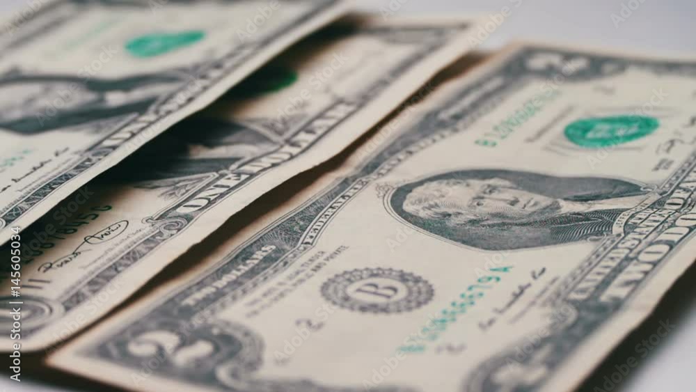 lot of small dollar bills fall on the table with a white background macro close up lot of small dollar bills fall on the table with a white background macro close up