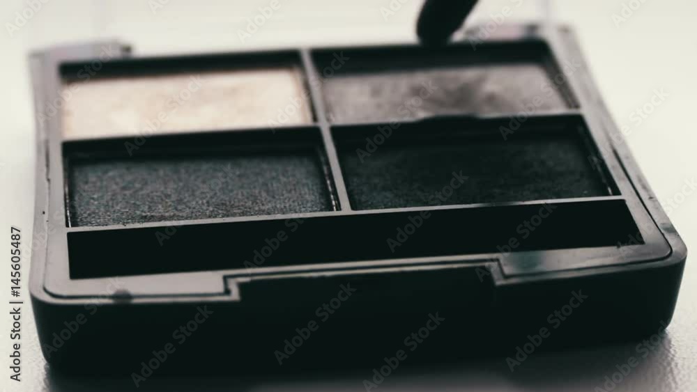 Gray shades of eyeshadow,Close up of makeup brush moving over eye shadows Gray shades of eyeshadow,Close up of makeup brush moving over eye shadows