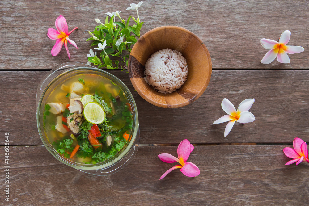 Northern Style Spicy Chicken Soup and rice on wood background Northern Style Spicy Chicken Soup and rice on wood background