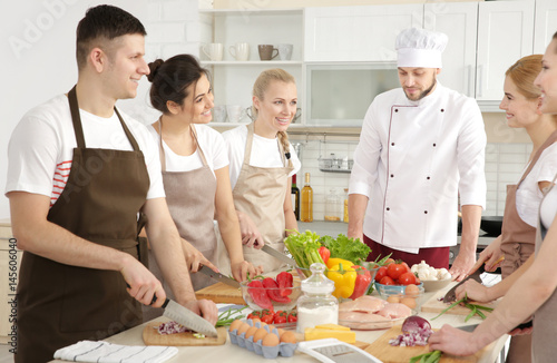 Male chef and group of peop...