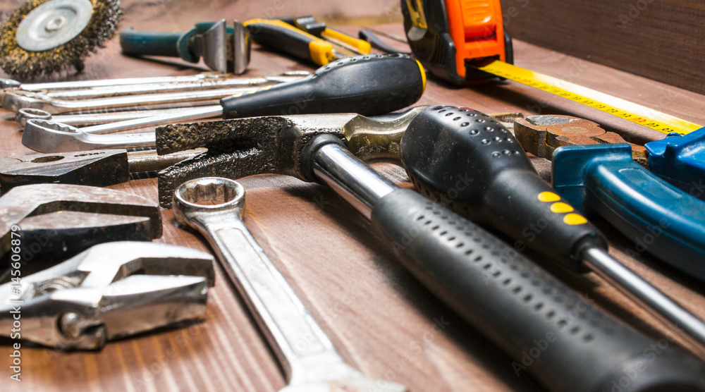 Set of hand tools on a wooden table Set of hand tools on a wooden table