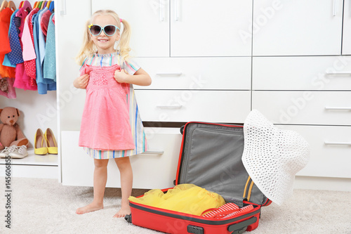 Cute small girl with clothe...