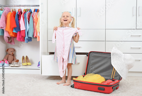 Cute small girl with clothe...