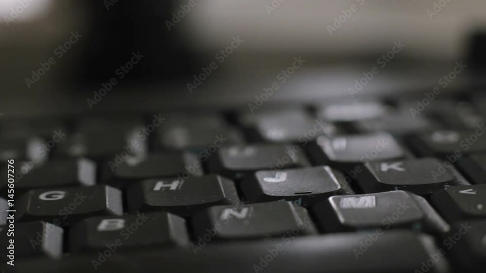 Keys of english pc keyboard close up sliding shot. Concept of technology and peripheral devices. Macro of buttons with letters and blurred background Keys of english pc keyboard close up sliding shot. Concept of technology and peripheral devices. Macro of buttons with letters and blurred background