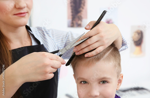 Cute little boy in hairdres...