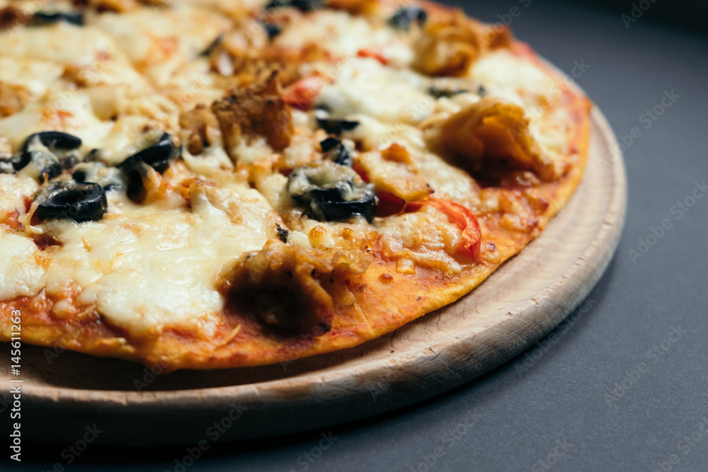 Homemade pizza with tomatoes, mozzarella and basil. Top view with copy space on dark stone table Homemade pizza with tomatoes, mozzarella and basil. Top view with copy space on dark stone table
