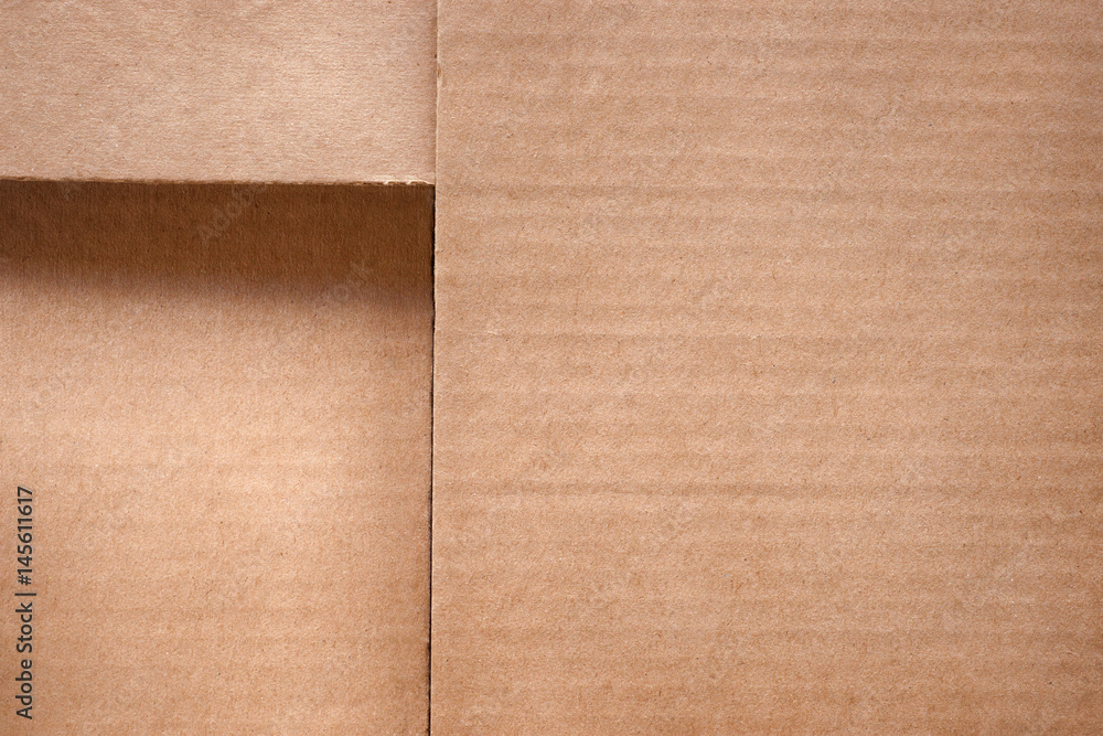 Fototapeta premium Folded cardboard box cover close up. Texture and background